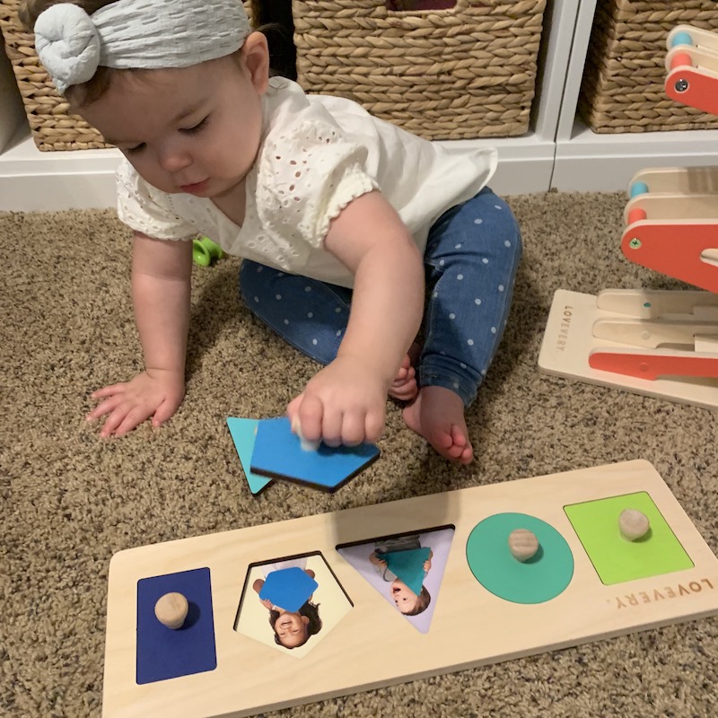 This picture shows a toddler playing with a LOVEVERY play kit. Are you wondering how to play with your toddler? This post will introduce you to the LOVEVERY Play Kits! This toy subscription box is full of developmental toys for your baby and a play guide to tell you how to play with your baby and what to do when!